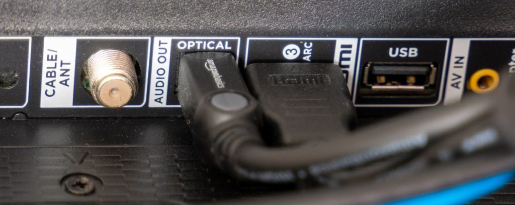 Image of the back of a monitor, showing various display ports such as HDMI, USB, Optical